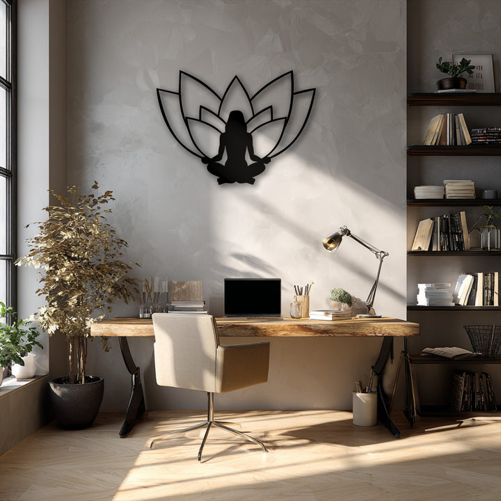 The abstract quality of this minimalist lotus meditation metal artwork is conveyed through a serene black silhouette against a textured wall.