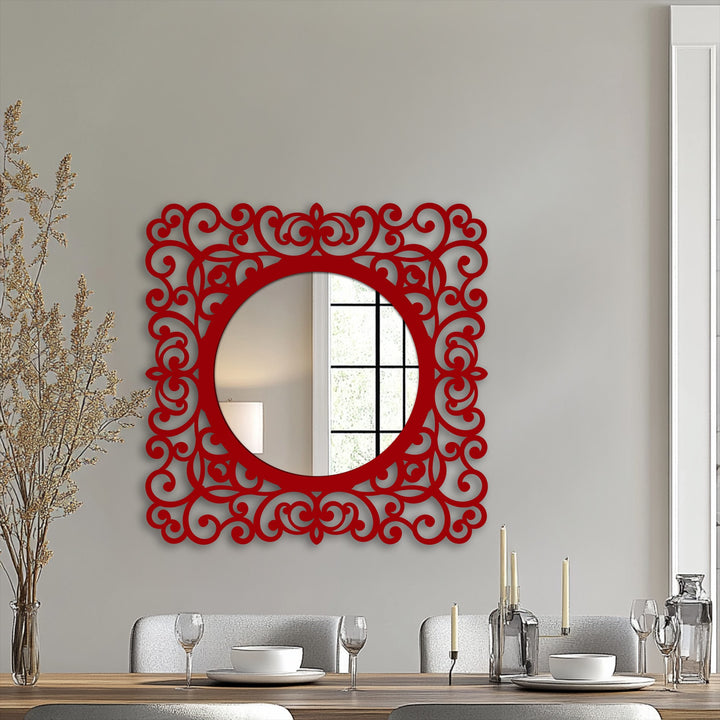 Highlighting its abstract quality, the ornate Baroque scroll frame around the round mirror resembles a contemporary metal wall decor art piece.