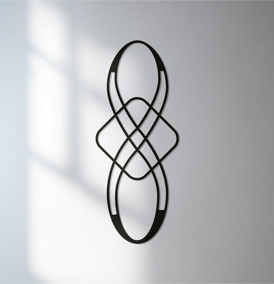 Highlighting the layering effect, this decorative metal art features an infinity loop in a black abstract sculpture, creating depth.