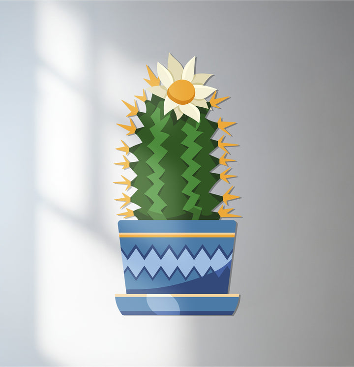 Illuminated by the brightest area, this decoration wall art features a flowering cactus in a blue pot, a modern and colorful botanical metal wall art piece.