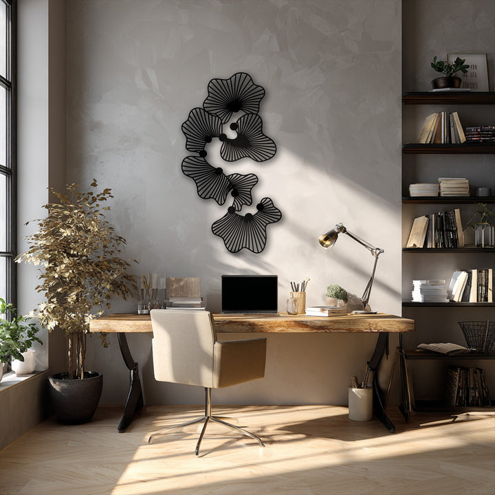 Crafted from high-quality metal, this sleek abstract floral metal artwork features a modern line flower design above a natural wood desk.