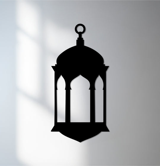 Negative space defines a hanging wall art lantern silhouette, casting intricate shadows that enhance this Islamic Ramadan metal wall art.