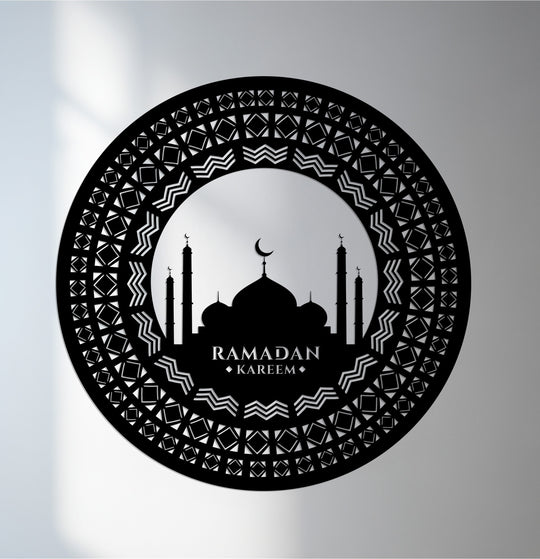 Finished in black, this unique metal wall art features a detailed, geometric-patterned border framing a mosque silhouette and 'Ramadan Kareem' inscription.
