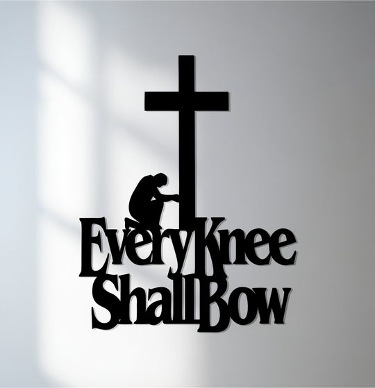 A minimalist, abstract metal wall art depicts a cross with a kneeling figure, conveying a profound spiritual message.