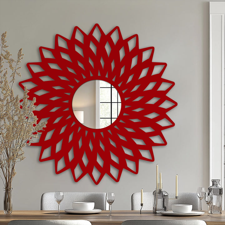The reflection in this bathroom mirror reveals a subtle transition between colors, framed by a vibrant red geometric flower design.