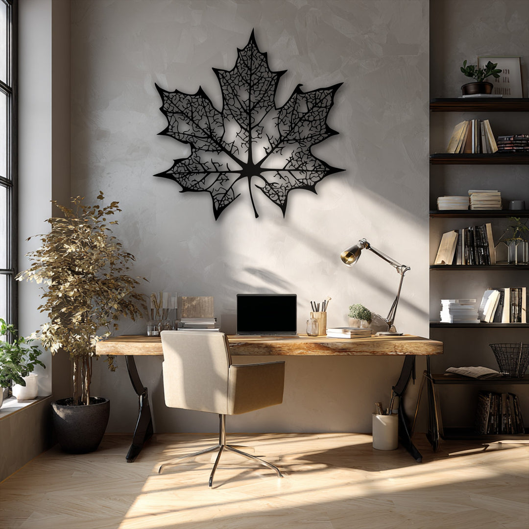The darkest area showcases an intricate black maple leaf metal wall decor, its detailed silhouette creating a striking contrast on a textured wall.
