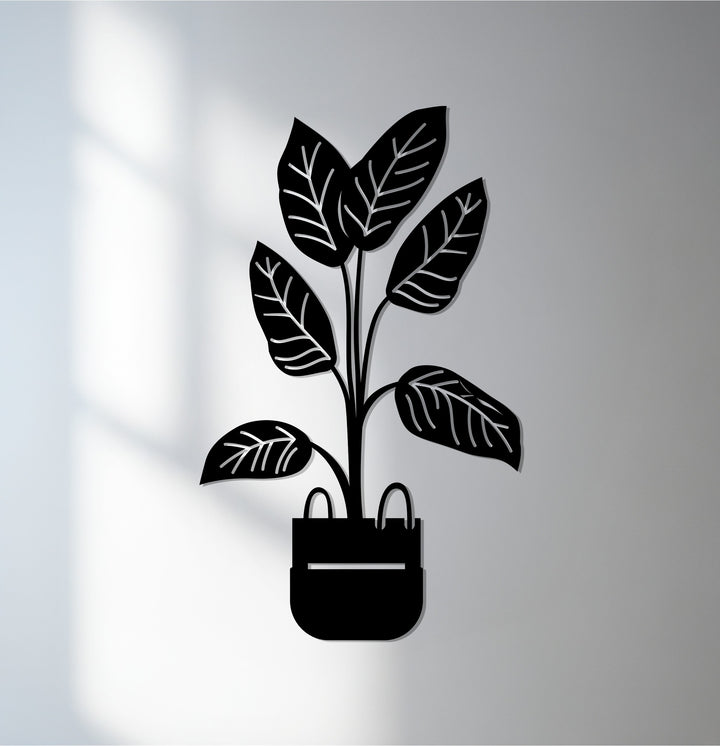Illuminated by the brightest area, this modern potted plant decoration wall art exemplifies botanical minimalist decor crafted in metal.