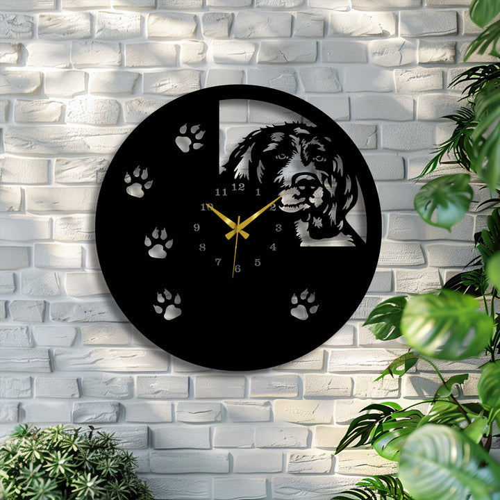 The sleek, matte black finish of this unique metal wall art clock features a distinctive laser-cut dog silhouette and paw print design.