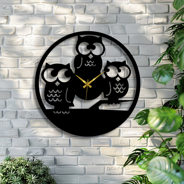 A bright, cool color temperature illuminates the striking Three Owls Silhouette Metal Wall Clock, a captivating metal wall decor piece on a white brick.
