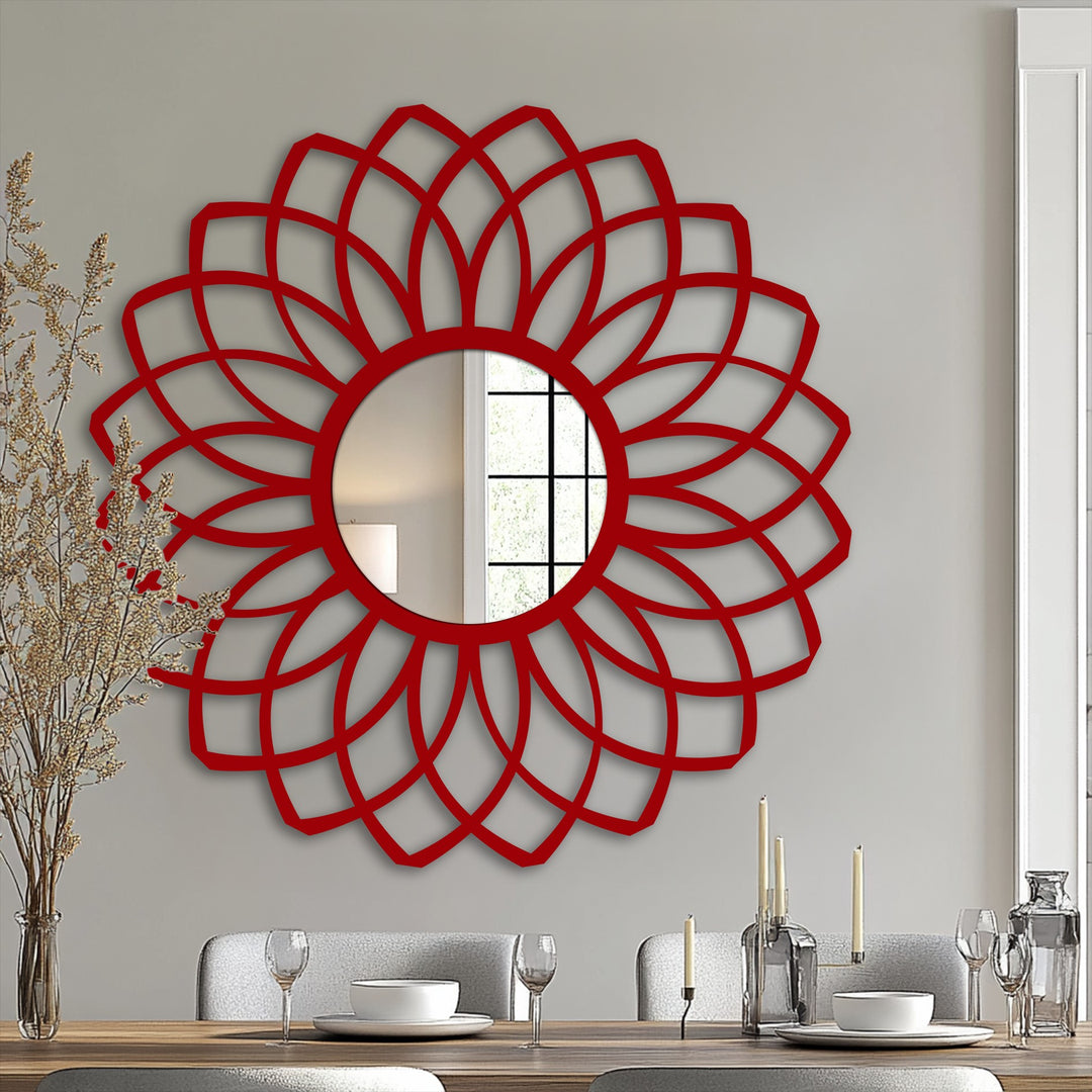 Highly saturated red frames a circular framed wall mirror featuring a modern floral layered petal design, enhancing the wall's color.