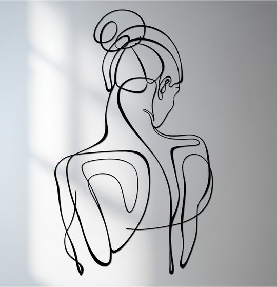 Black defines this minimalist line silhouette of an abstract woman in decorative metal art.