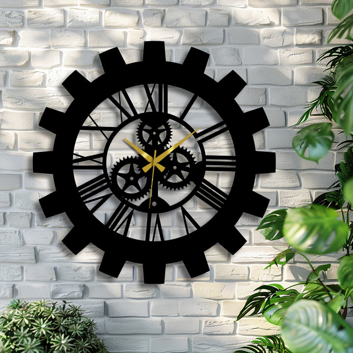 Shadows define the gears and Roman numerals of the Industrial Gear Roman Numeral metal art for wall, highlighting its detailed construction and texture against the white brick.