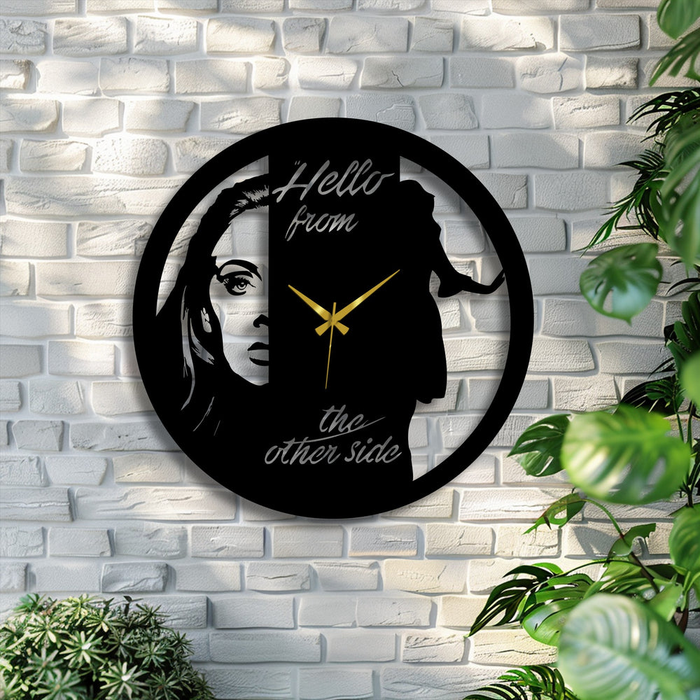 Suggesting movement, the dual face metal artwork clock captures the illusion of shifting perspectives in its artistic portrait silhouette.