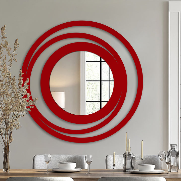 Swirling rings of a floor mirror encircle a central reflection, creating a stained glass wall mirror that suggests an almost dizzying, hypnotic sense of movement.