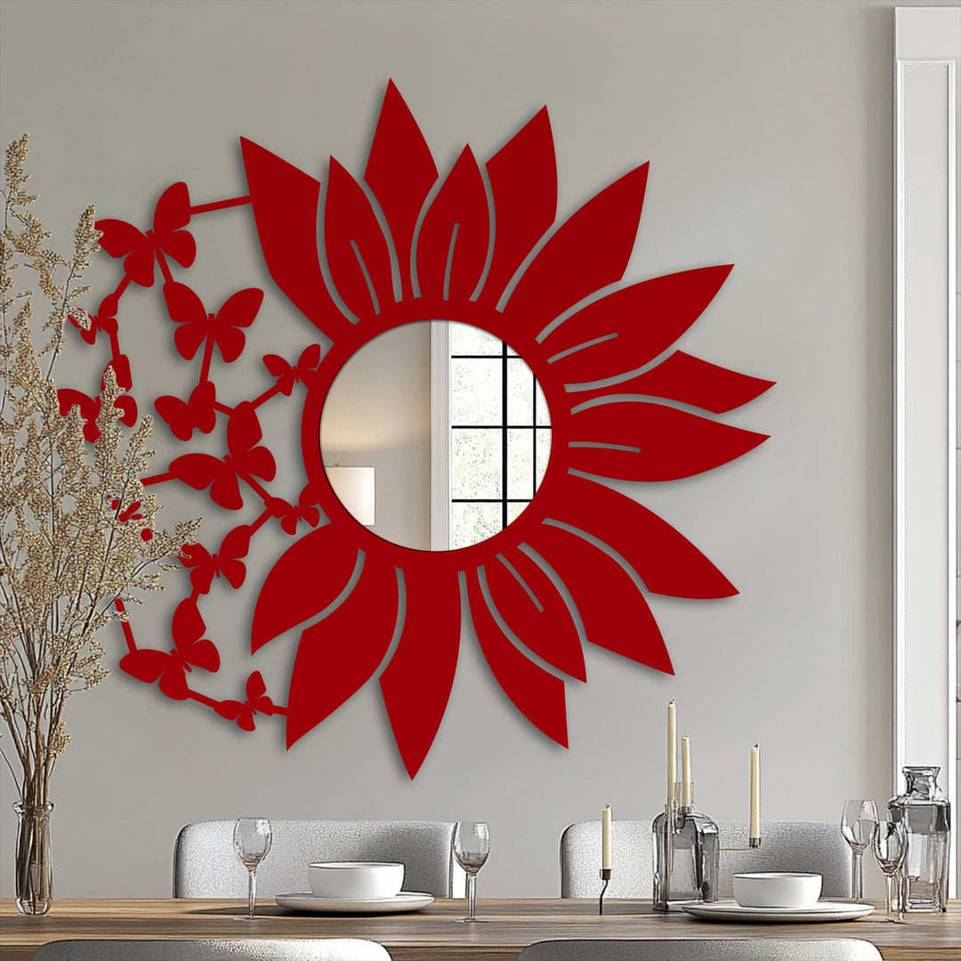 Foreground view of a dining table beneath a decorative modern wall mirrors accent, showcasing a sunflower mirror and butterfly blooms.