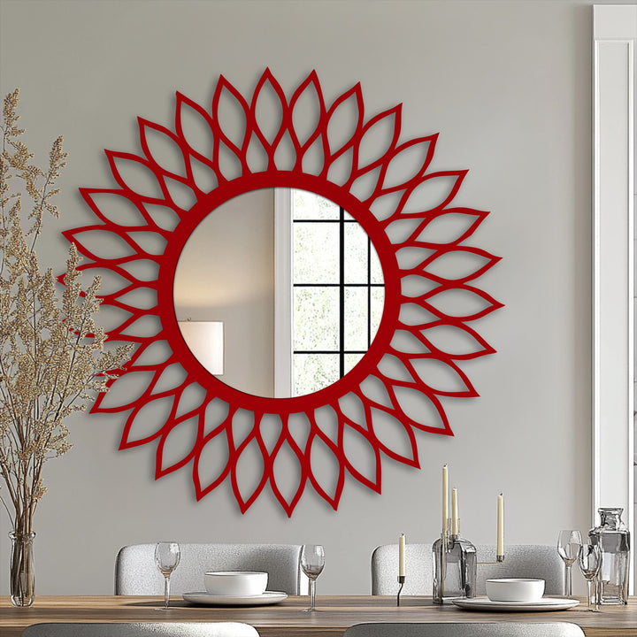 Subtle light and shadow play across the radiant leaf halo frame surrounding the round bathroom mirror, enhancing its decorative design and illuminating the reflective glass.