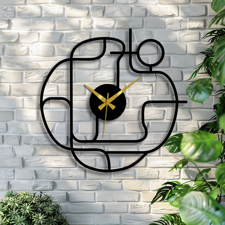 Striking color contrast showcases the abstract continuous line of the modern metal art for wall clock, accented by gold hands on a white brick background.