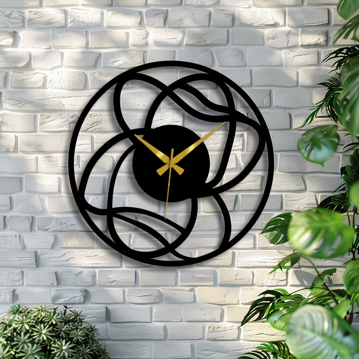 The stillness emphasizes the intricate interwoven design of the modern abstract metal art for wall clock, a geometric decorative piece frozen in time on the brick wall.