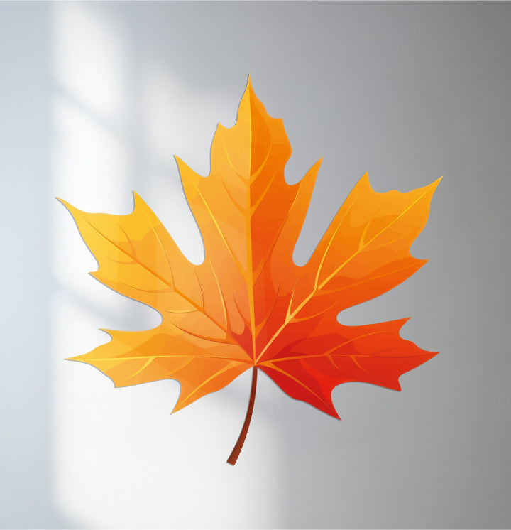 Light and shadow play across the decoration wall art of a golden autumn maple leaf, accentuating its modern, fall-inspired design.