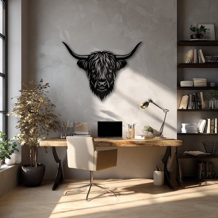 A textured light gray wall serves as the perfect background for the unique metal wall art featuring a majestic Highland bull head.