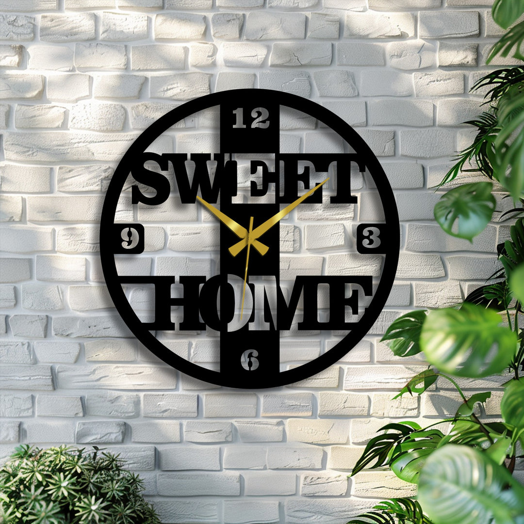 A rustic white brick wall serves as the textured background for this unique metal wall art clock featuring 'Sweet Home' in a modern design.