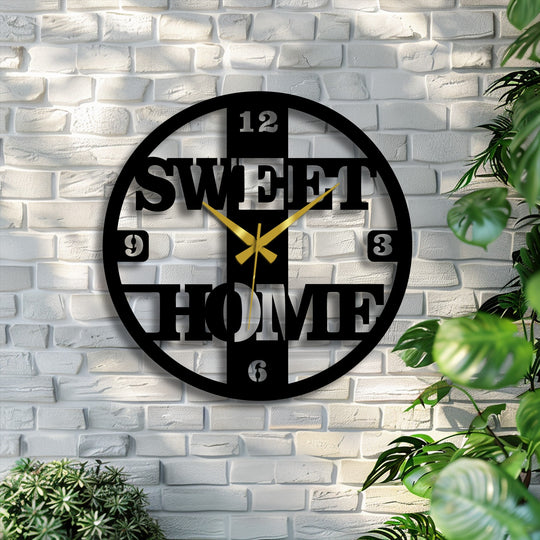 A rustic white brick wall serves as the textured background for this unique metal wall art clock featuring 'Sweet Home' in a modern design.