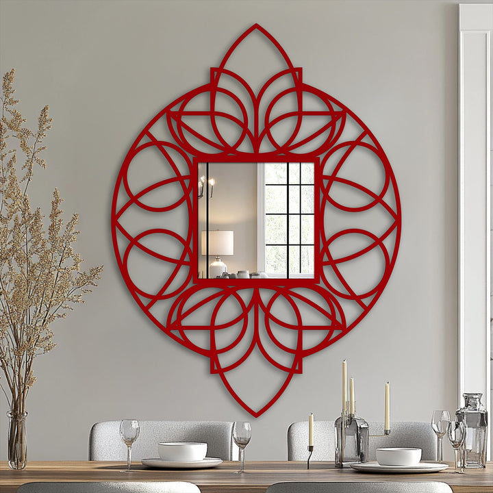 The artistic negative space in the geometric floral mandala reveals the framed wall mirror, creating a striking decorative metal artwork focal point on the wall.