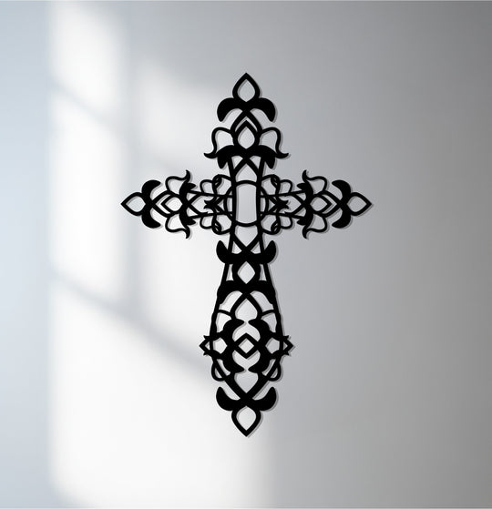 Layers of depth create a striking effect in this unique metal wall art, showcasing the intricate design of the ornamental black cross.