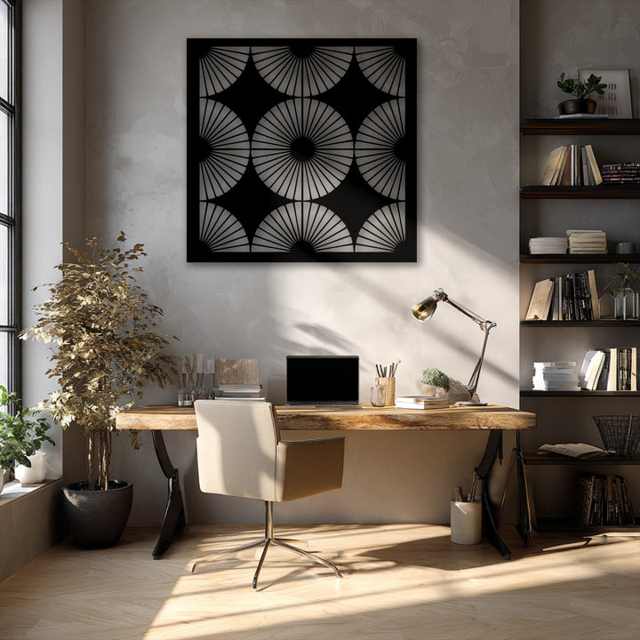 Bold black metal artwork showcasing a radiant fan pattern with geometric symmetry, perfectly complementing the modern office decor.