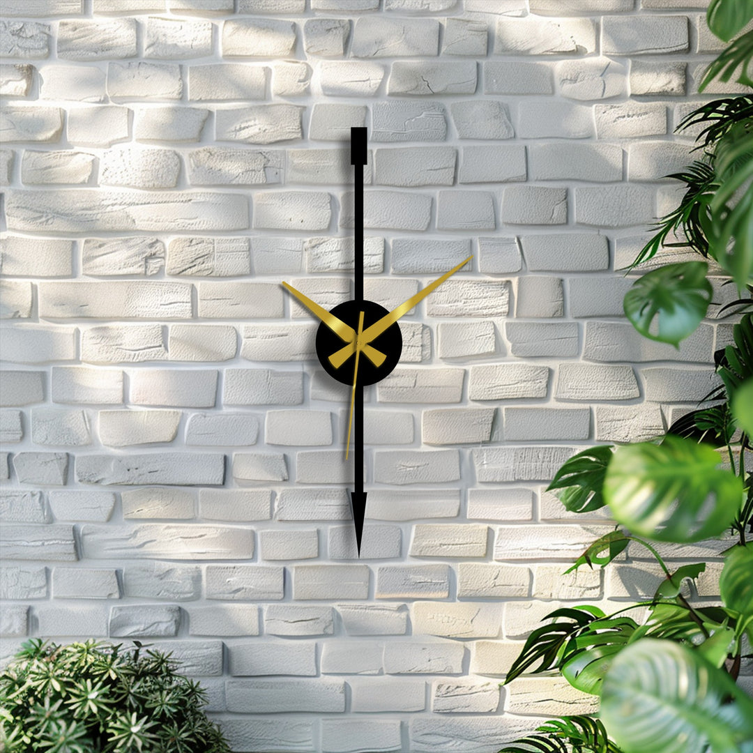 Defined edges and borders highlight the minimalist vertical arrow design of this modern metal wall decor clock with its bold black and gold accents.