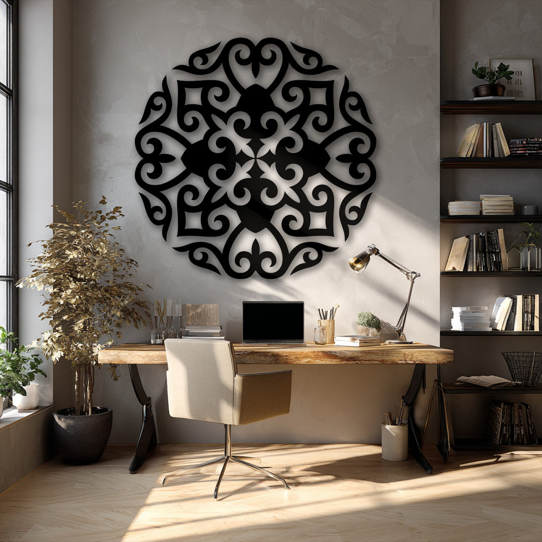 The striking, large black ornate floral mandala metal art for wall prominently dominates the textured grey wall, illuminated by natural light.