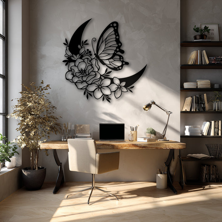 The darkest area highlights the elegant butterfly and floral crescent decorative metal art, showcasing its intricate design against a textured wall.