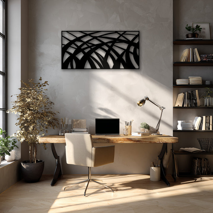 The abstract metal wall decor features flowing geometric lines creating intricate depth and layers, casting striking shadows on the light gray wall.