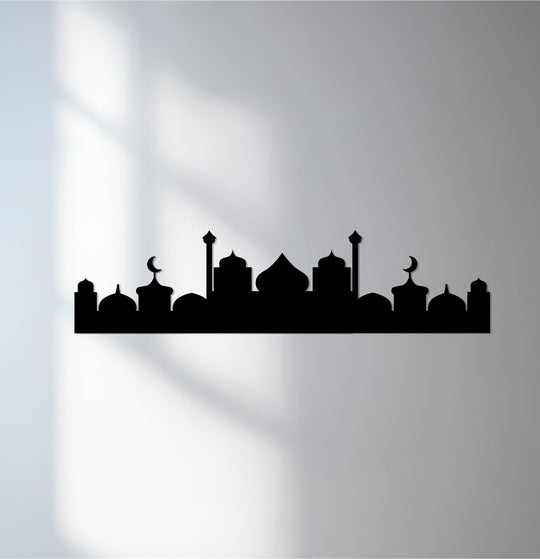 Shadows dance and swirl across this unique metal wall art depicting a minimal Islamic silhouette, giving the crescent dome skyline a fluid, almost kinetic, essence.