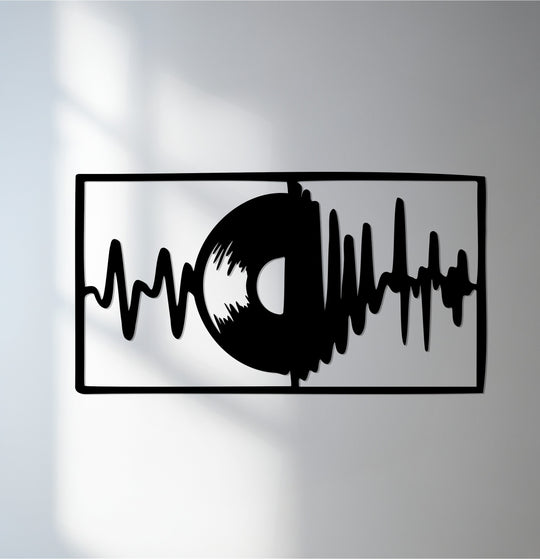 Cool color temperatures accentuate the modern black metal wall decor depicting a vinyl soundwave, creating a visually striking piece of music-inspired metal wall art.