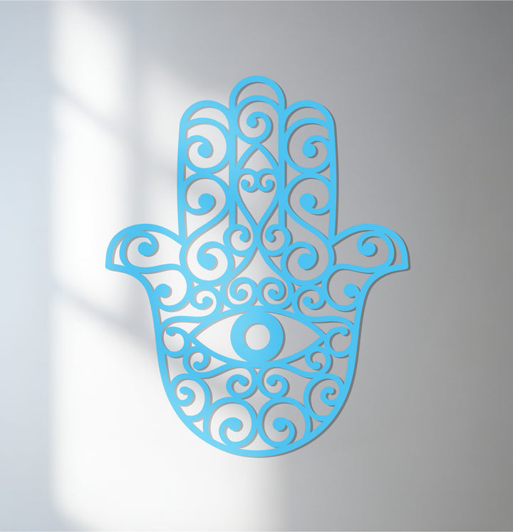 Vertical hamsa hand-shaped decorative metal art features an intricate, spiraled design with an integrated evil eye symbol.