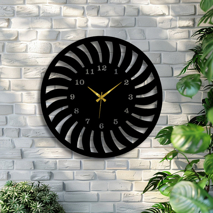 The striking black metal wall clock, a captivating decoration wall art piece, features a modern radial spiral design and gleaming gold hands.