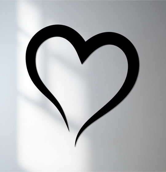 Defined edges highlight the heart's silhouette in this minimalist piece of metal wall decor, perfect for adding a touch of love.