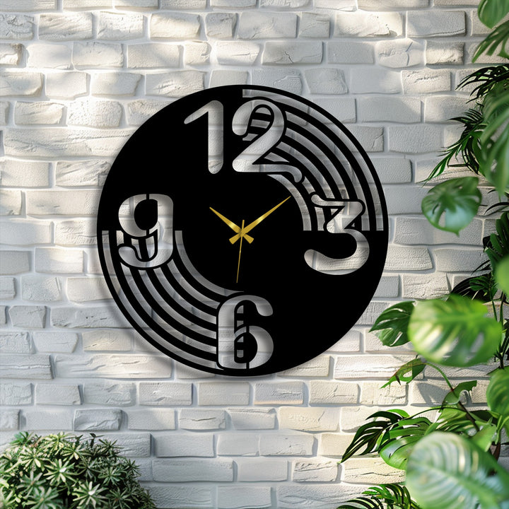 The stillness of the Modern Flow Number Metal Wall Clock, a metal wall decor, displays bold numbers and golden hands on a white brick wall.