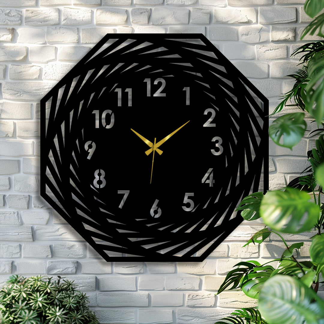 Brightest area highlights the gold hands and silvery numbers of the modern spiral geometric decorative metal art wall clock mounted on a textured brick background.