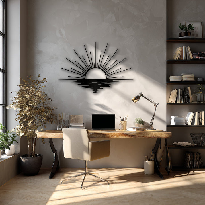 A softly textured wall beautifully highlights the smooth, matte black surface of the sun rays ocean metal art for wall, portraying a serene sunset.