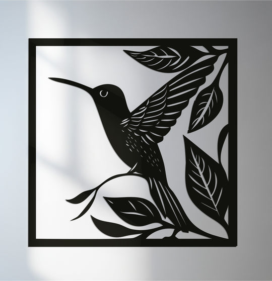 Illuminated by the brightest area, this decorative metal art features a graceful hummingbird and foliage design in a square frame.