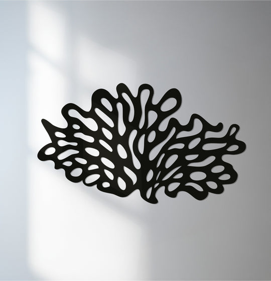 Low color saturation emphasizes the black silhouette of this coral reef metal wall art, presenting it as a standout piece of unique metal wall art.