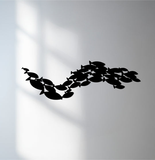 Black is the dominant color in this unique metal wall art featuring an Ocean Harmony school of fish design.
