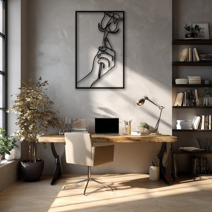 The minimalist hand holding rose metal artwork demonstrates a striking transition from sun-drenched warm hues to cool, deep shadows.