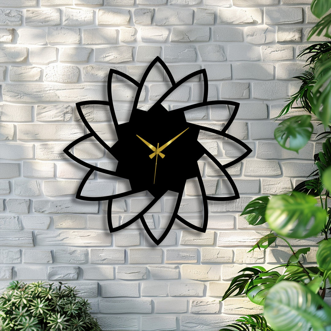 Displaying a lotus bloom decorative metal art, this wall clock features a minimalist floral design with elegant gold hands, mounted on a textured white brick wall.