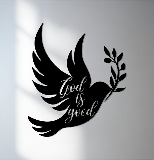 Organic shapes form a graceful dove carrying an olive branch, part of this faith-inspired unique metal wall art piece declaring 'God is good.'
