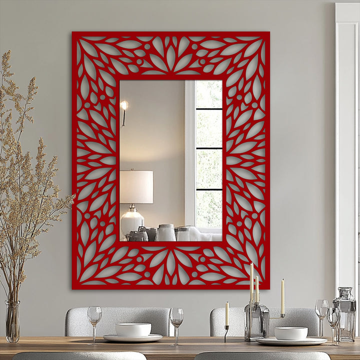 Shifting from the gray wall to the deep red, this intricate floral pattern enhances the framed wall mirror's elegant decorative frame, a bold statement of metal wall decor.