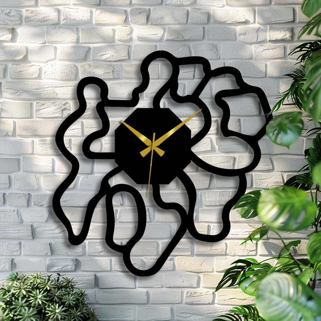 Black dominates this modern abstract metal art for wall clock, featuring an organic shape and gold hands for a striking contrast on the textured brick.