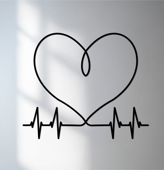 Bold decorative metal art contrasts against a soft, light wall, highlighting the heart pulse design in this modern love metal wall art piece.